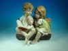 14"polyresin pair country kids reading on bench